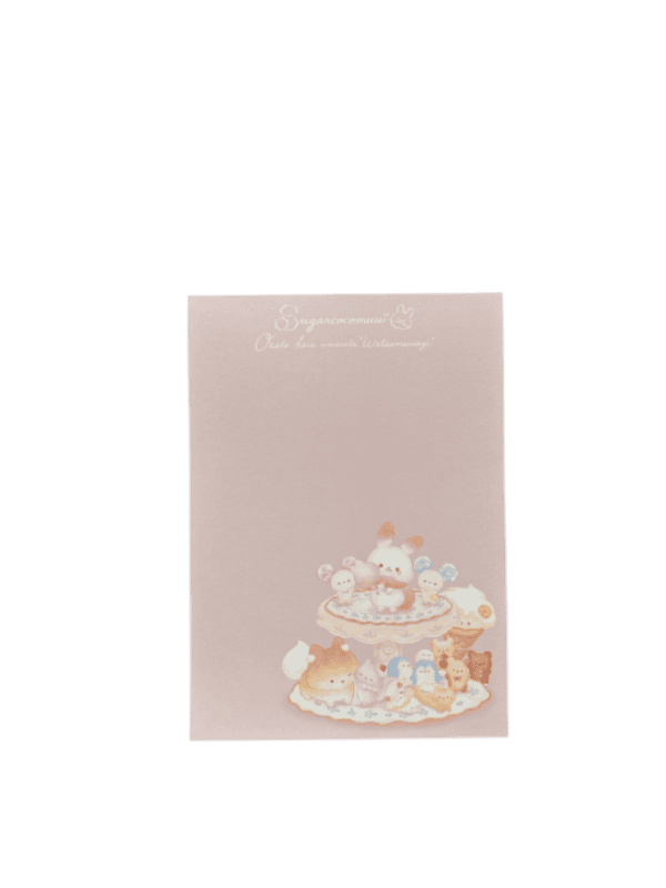 Pink memo pad sheet featuring the main Sugar Cocomuu character group illustration at the bottom and cursive logo text at the top.