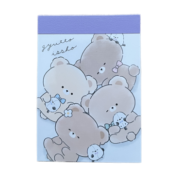 Front cover of a Crux Gyutto Issho mini memo pad featuring an illustration of fluffy teddy bears cuddled up while holding tiny long-tailed tit (Shimaenaga) birds on a light blue background.