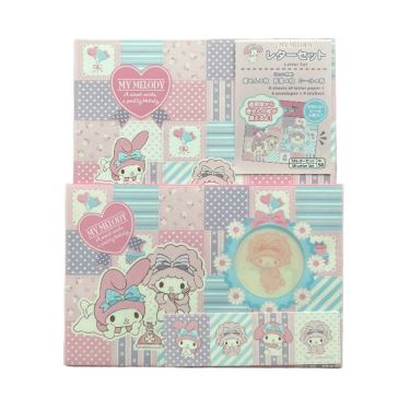 Front view of the packaged Sanrio letter set featuring My Melody and My Sweet Piano, displaying the product header card, patterned letter sheets, and window envelopes against a black background.